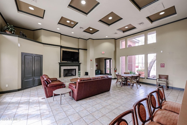 5401 E Van Buren St Unit 2095, Phoenix, AZ 85008 - living room with visible vents, a towering ceiling, crown molding, a fireplace, and light tile patterned flooring