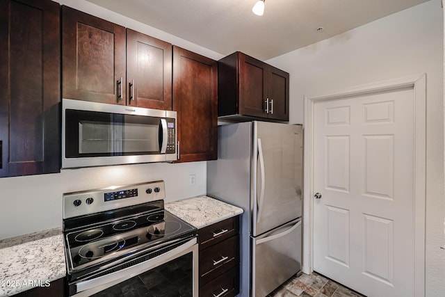 5401 E Van Buren St Unit 2095, Phoenix, AZ 85008 - kitchen with light stone countertops, stone finish floor, stainless steel appliances, and dark brown cabinets