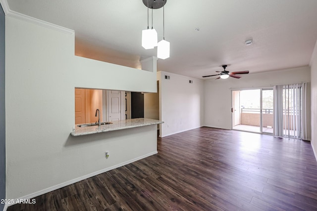 5401 E Van Buren St Unit 2095, Phoenix, AZ 85008 - unfurnished living room with dark wood-type flooring, a sink, a ceiling fan, baseboards, and crown molding