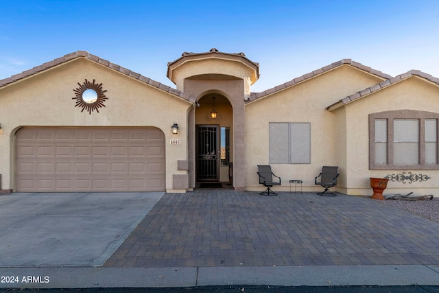 mediterranean / spanish-style home featuring a garage