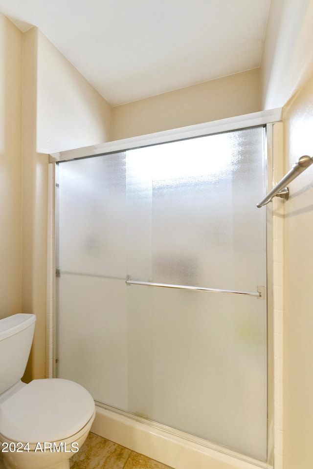 bathroom featuring toilet and walk in shower