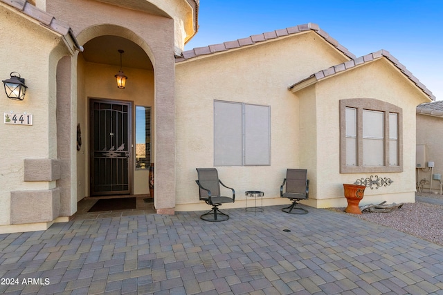 entrance to property featuring a patio