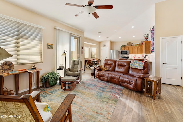 living room featuring light wood-type flooring and ceiling fan