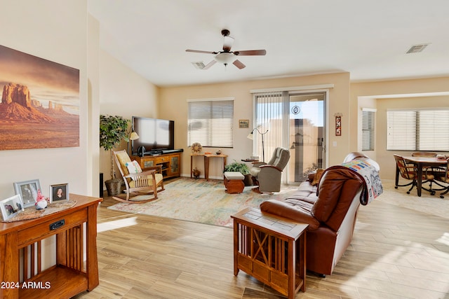 living room with light hardwood / wood-style flooring and ceiling fan