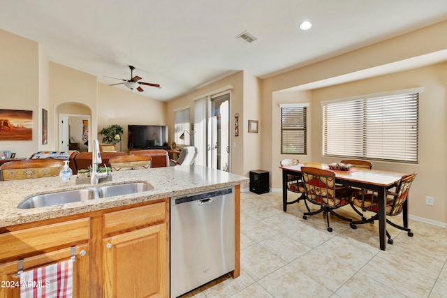 kitchen with sink, vaulted ceiling, plenty of natural light, and dishwasher