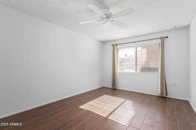 spare room with ceiling fan, a textured ceiling, and dark hardwood / wood-style flooring