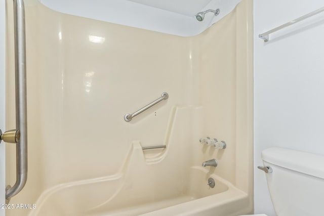 bathroom featuring toilet and bathtub / shower combination