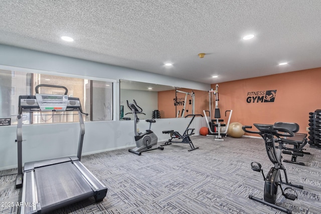 workout room with carpet and a textured ceiling