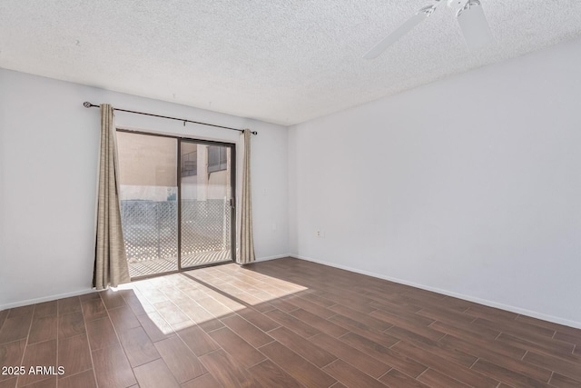 unfurnished room with ceiling fan and a textured ceiling