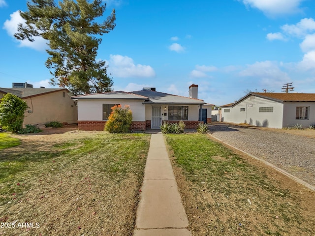 ranch-style house with a porch and a front lawn