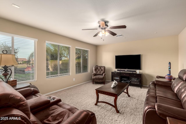 living room featuring light carpet, ceiling fan, and baseboards