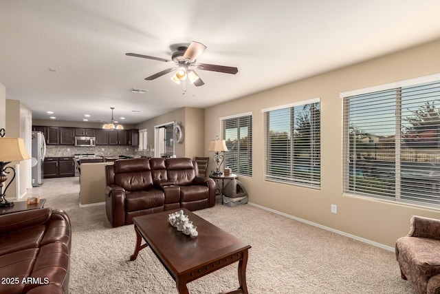 living room featuring recessed lighting, light colored carpet, visible vents, a ceiling fan, and baseboards