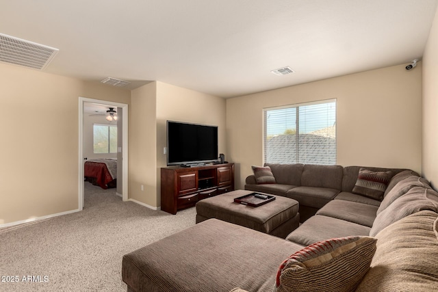 living area with carpet, visible vents, and baseboards