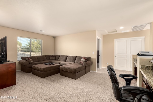 living area with light colored carpet, visible vents, and baseboards