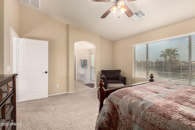 bedroom featuring arched walkways, lofted ceiling, visible vents, light carpet, and multiple windows