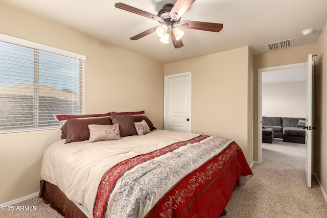 bedroom with baseboards, ceiling fan, visible vents, and light colored carpet