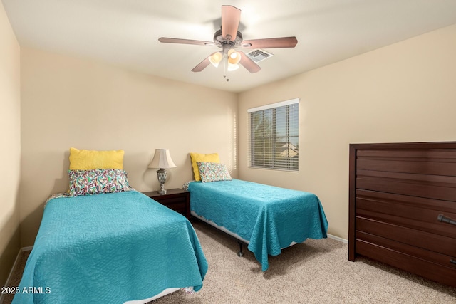 bedroom featuring baseboards, carpet, visible vents, and a ceiling fan