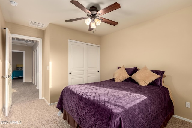 bedroom featuring baseboards, visible vents, and light colored carpet