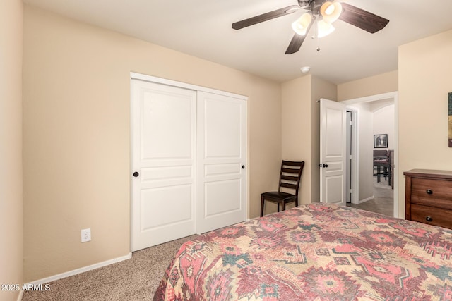 carpeted bedroom with a ceiling fan, a closet, and baseboards