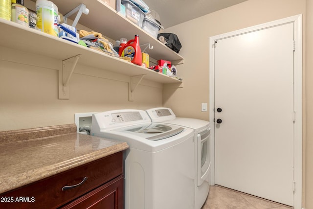 washroom featuring laundry area, independent washer and dryer, and light tile patterned floors