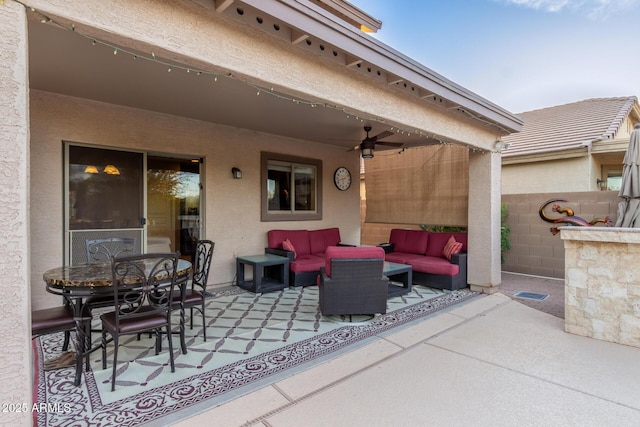 view of patio with outdoor dining area, ceiling fan, visible vents, and outdoor lounge area