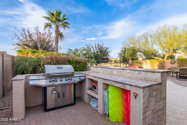 view of patio / terrace with a fenced backyard, a grill, and area for grilling