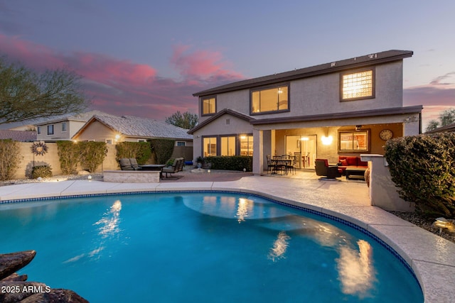 view of pool featuring a patio area, fence, an outdoor living space, and a fenced in pool