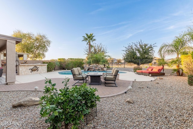 view of patio / terrace featuring a fenced backyard, an outdoor kitchen, and a fenced in pool