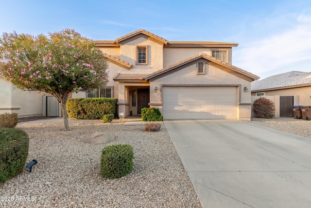 traditional-style house featuring a tile roof, stucco siding, an attached garage, fence, and driveway