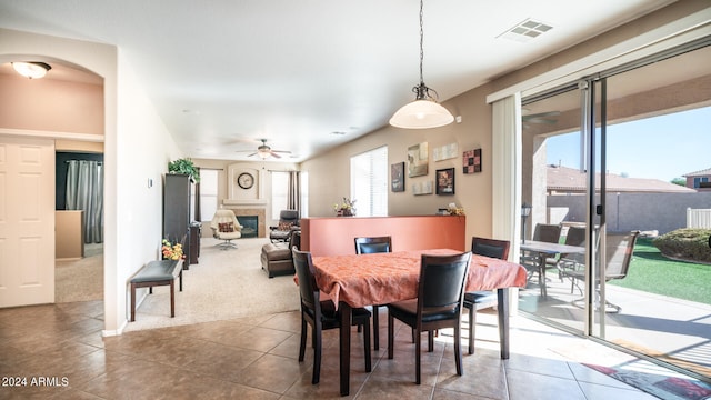 dining area featuring ceiling fan and carpet