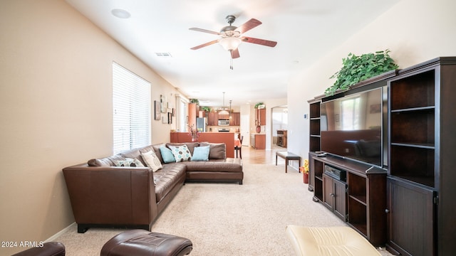 living room with ceiling fan and light carpet