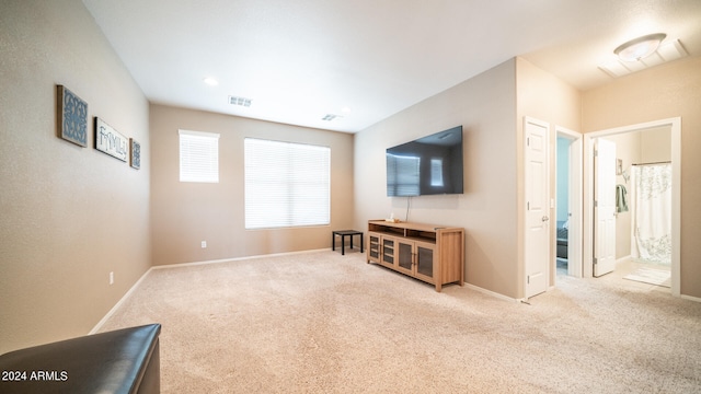 unfurnished living room with light colored carpet