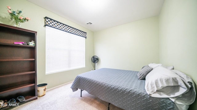 bedroom featuring light carpet and vaulted ceiling