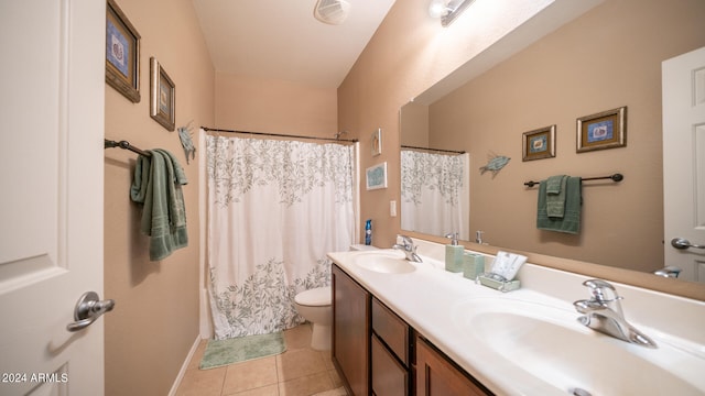 bathroom with vanity, toilet, and tile patterned flooring