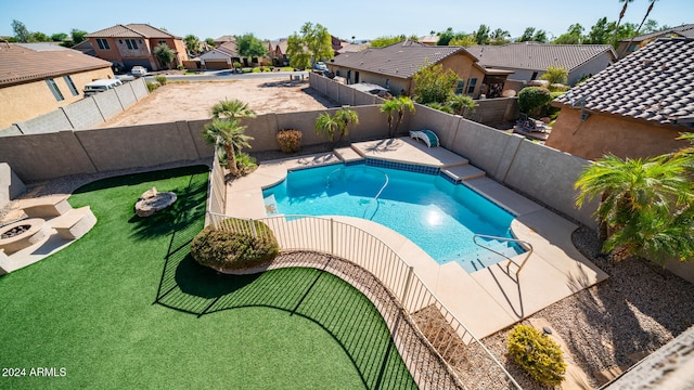 view of pool with a lawn