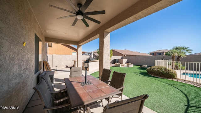 view of patio with an outdoor living space, a fenced in pool, and ceiling fan