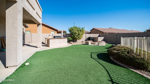 view of yard featuring a patio area and exterior kitchen