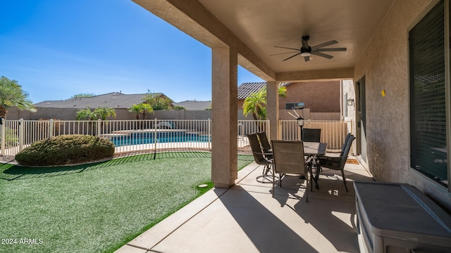 view of patio / terrace with a fenced in pool and ceiling fan