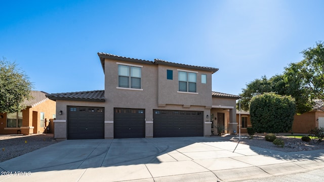 mediterranean / spanish house with a garage