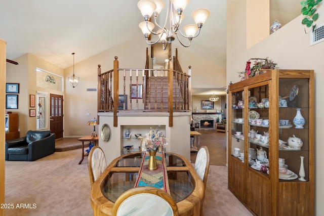 4002 N San Gabriel Cir, Mesa, AZ 85215 - dining area with a chandelier, carpet, high vaulted ceiling, and a stone fireplace