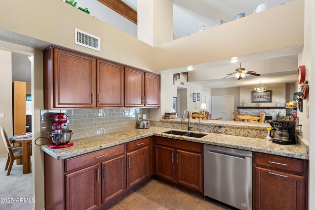 4002 N San Gabriel Cir, Mesa, AZ 85215 - kitchen with stainless steel dishwasher, a peninsula, a ceiling fan, tasteful backsplash, and light stone countertops
