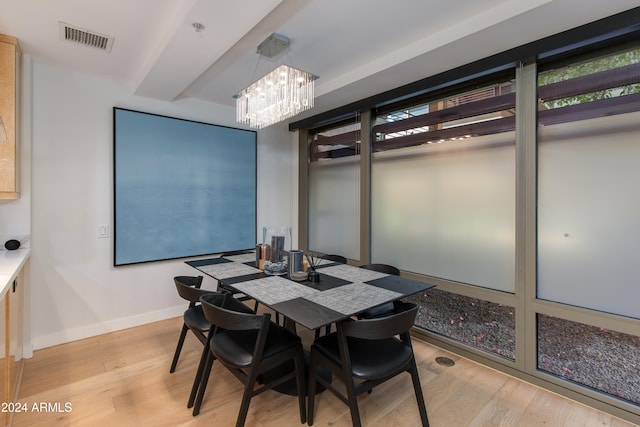 dining area featuring light hardwood / wood-style floors and a chandelier