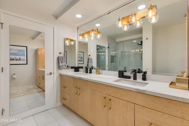 bathroom featuring a shower with door, vanity, and tile patterned flooring