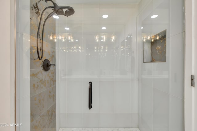 bathroom with a shower with door