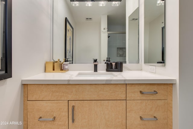 bathroom with vanity and an enclosed shower