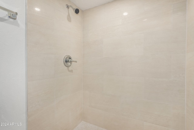 bathroom with a tile shower