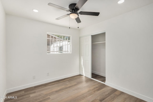 unfurnished bedroom featuring a closet, ceiling fan, and wood-type flooring