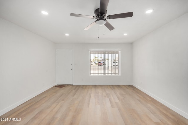 unfurnished room with light wood-type flooring and ceiling fan