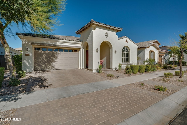 mediterranean / spanish home featuring a garage