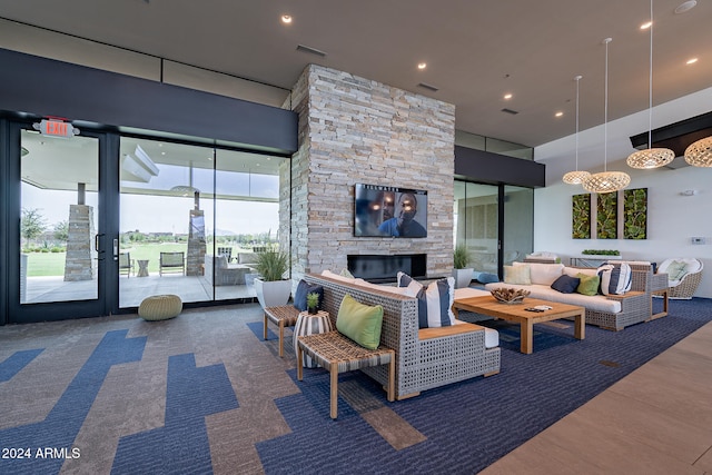 living room with an outdoor stone fireplace